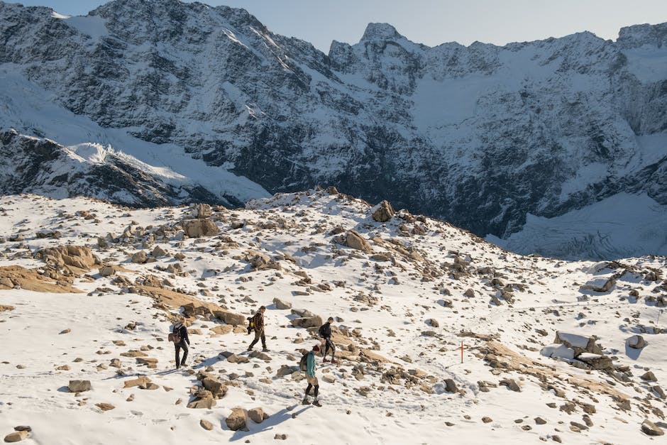 A group of children dressed in winter gear, playing happily in the snow